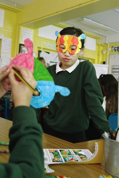 Pupils making masks in a classroom
